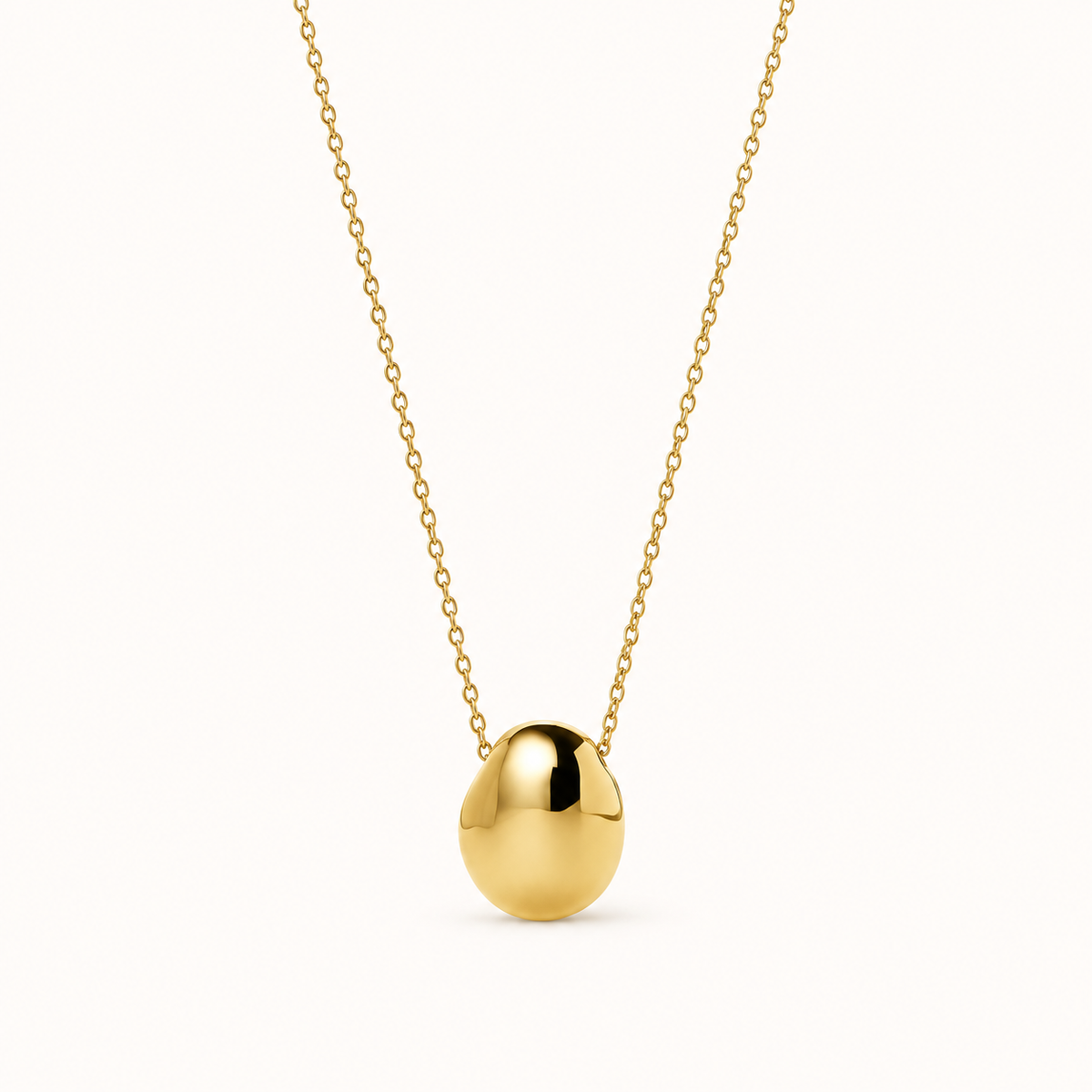 Gold Pebble Pendant Necklace on a plain white background, full chain and pendant