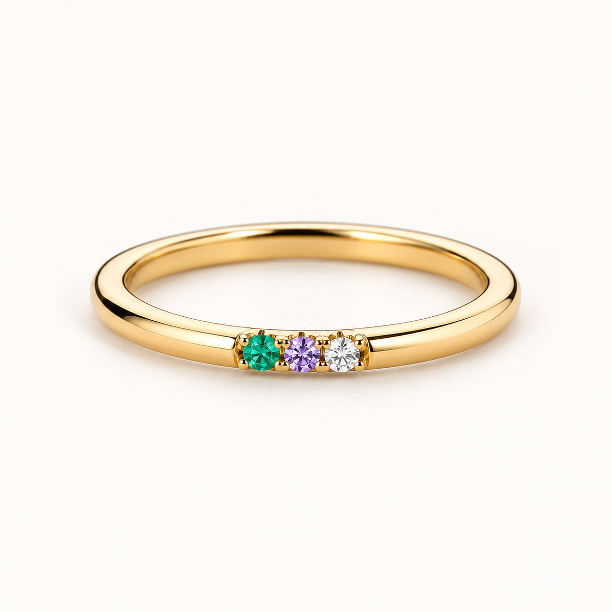 Three Stone Ring in gold on a plain white background, showing the three set stones