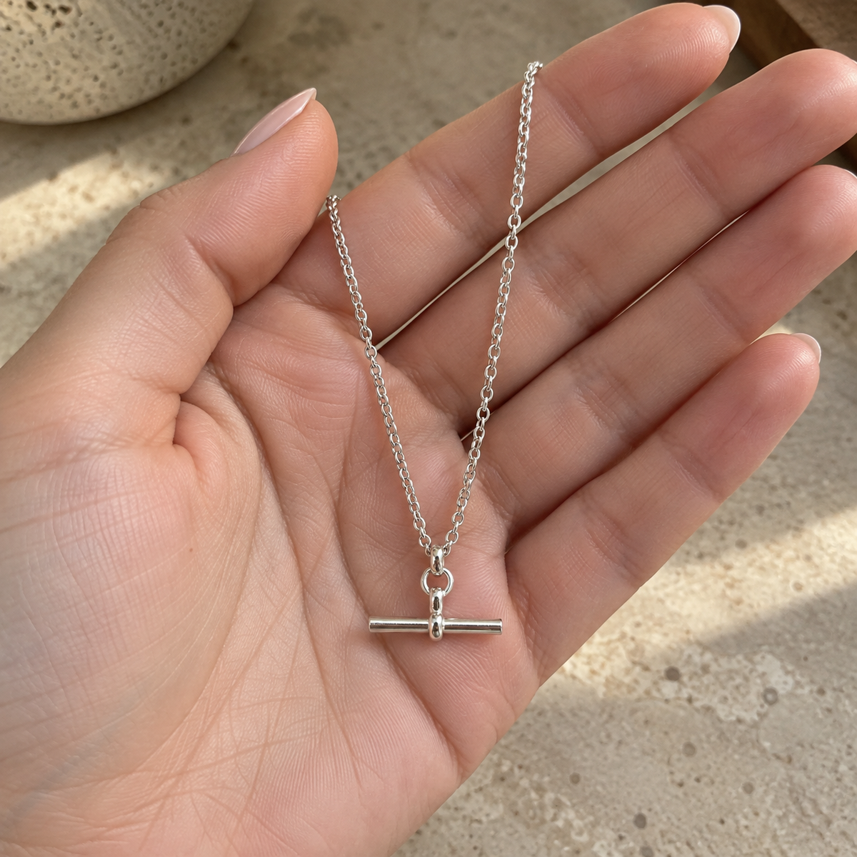 Silver T-Bar Chain held in an open hand for scale