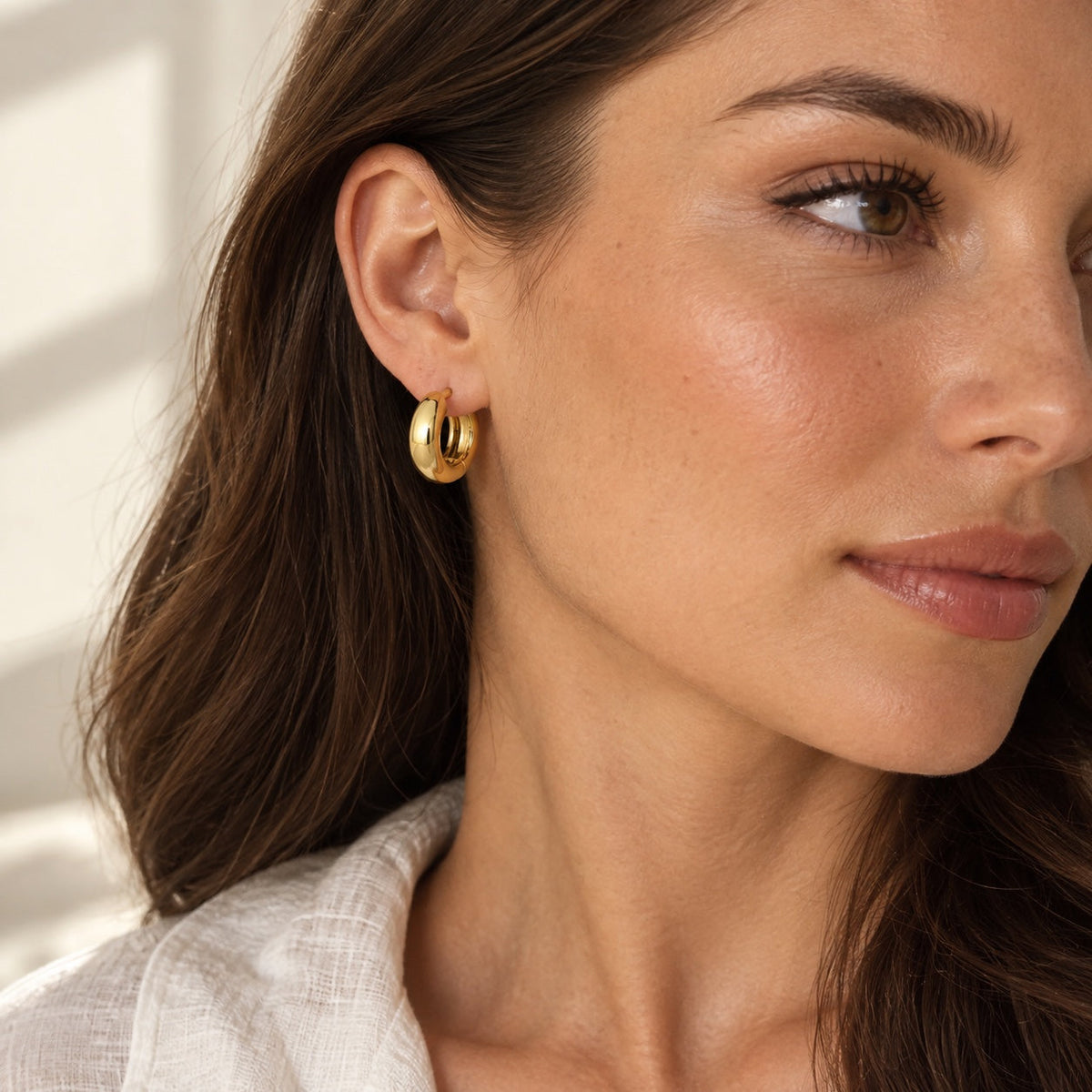 Chunky Huggie Hoops on model